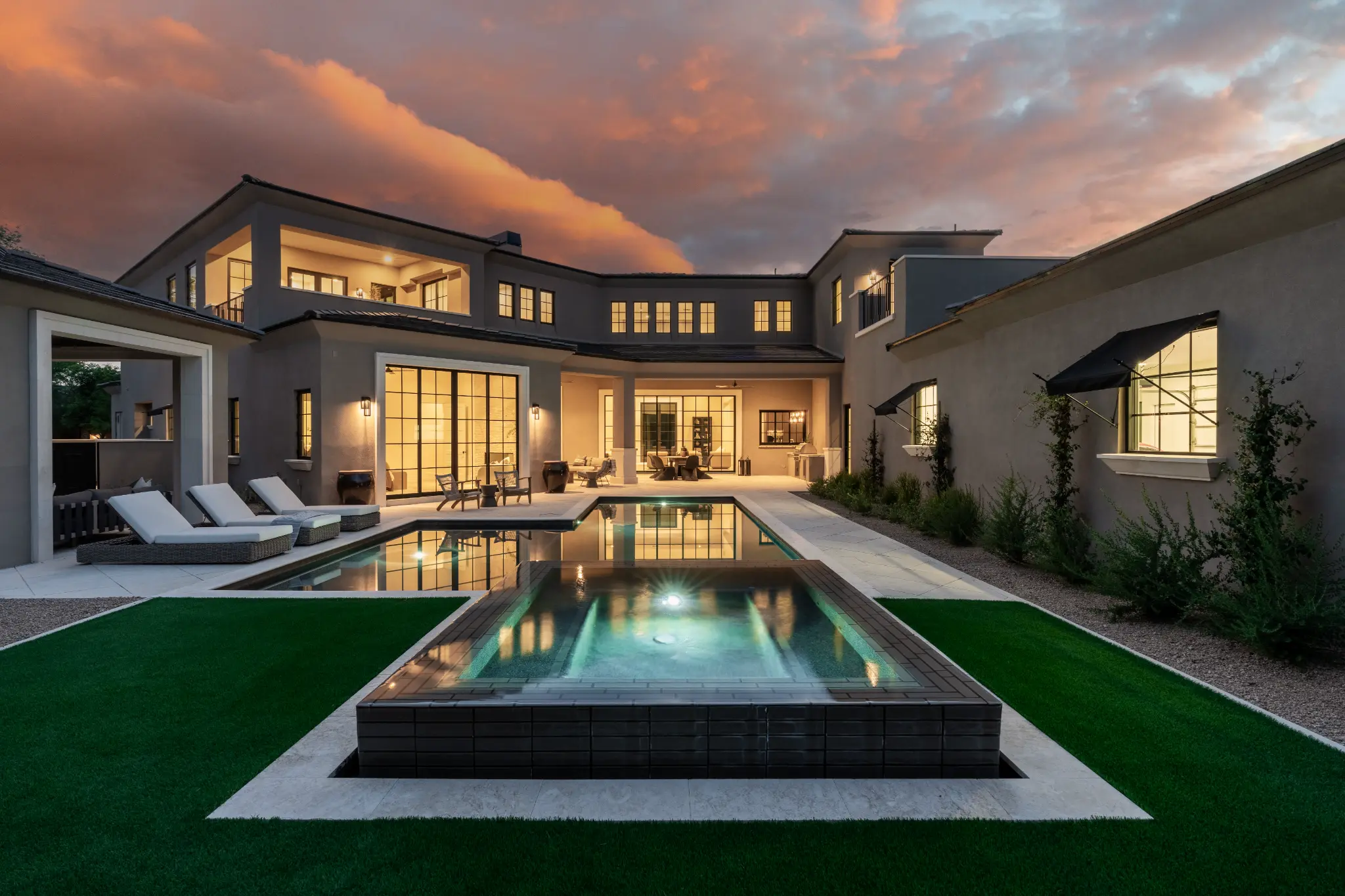 Arizona residence presented at sunset with illuminated pool